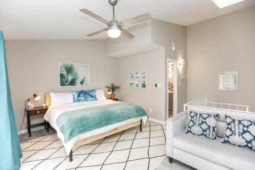 a bedroom with a bed and a couch at Sojourn The Ocean Breeze in Virginia Beach in Virginia Beach