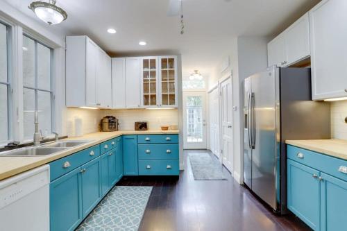 a kitchen with blue cabinets and a refrigerator at Sojourn Historic Location 2 BR 2 BA in Washington