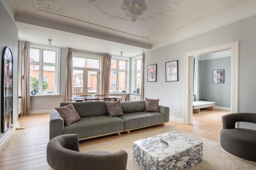 a living room with a couch and a table at Perfect Holiday Homes Near Amager Beach in Copenhagen