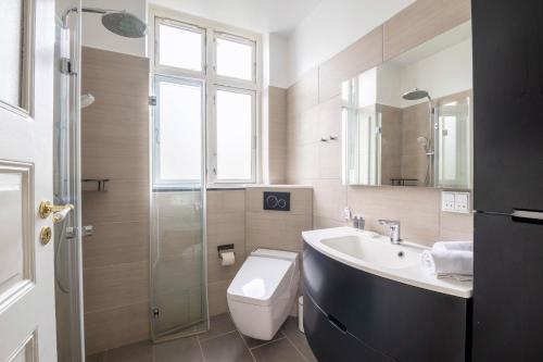 a bathroom with a toilet and a sink and a shower at Perfect Holiday Homes Near Amager Beach in Copenhagen