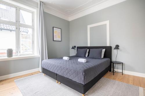a bedroom with a bed with two pillows on it at Perfect Holiday Homes Near Amager Beach in Copenhagen