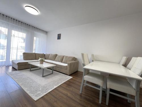 a living room with a couch and a table at City Center 1bedroom in Ferizaj