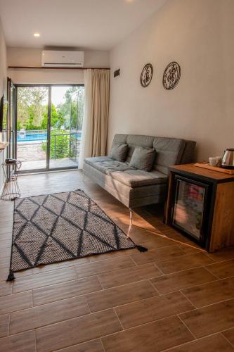 a living room with a couch and a fireplace at Assos Altın Hotel in Behramkale