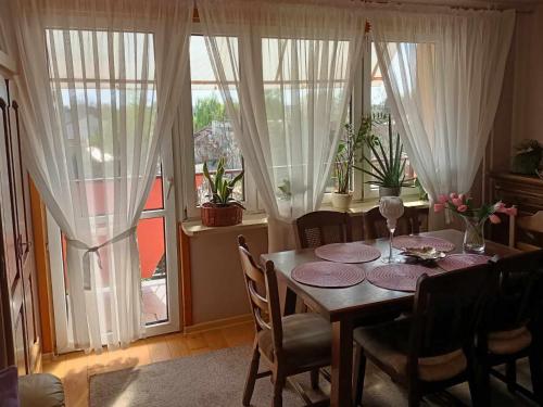 a dining room with a table and chairs and a window at Mieszkanie Mickiewicza ... 45 in Sandomierz