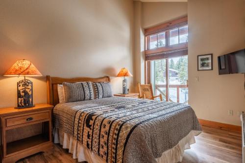 a bedroom with a bed and a window at Cabins 24 in Mammoth Lakes