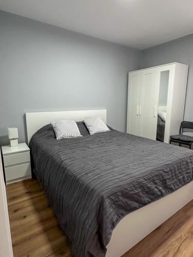 a white bedroom with a large bed and a mirror at Apartament - Lev Eilat 3 in Eilat
