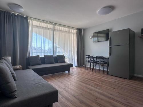 a living room with a couch and a dining room at Apartament - Lev Eilat 3 in Eilat