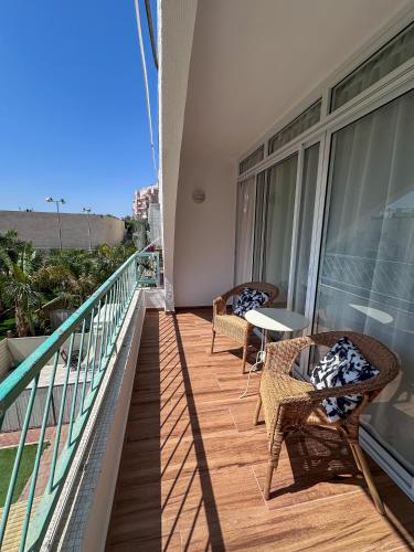 a balcony with two chairs and a table on a building at Apartament - Lev Eilat 3 in Eilat