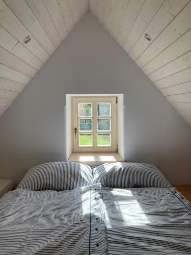 a bed in a room with a window at Domek Kavalírek in Lipova Lazne