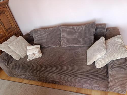 a couch with pillows on it in a room at Mieszkanie Mickiewicza ... 45 in Sandomierz