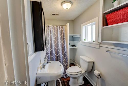 a bathroom with a white toilet and a sink at *H* NEW! Downtown Cottage Newly Renovated! * in Colorado Springs