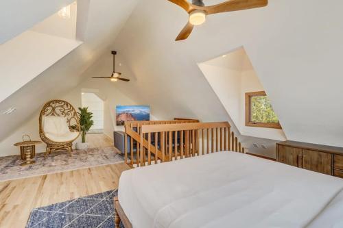 a bedroom with a white bed and a staircase at Garden of the Gods Base Camp Dog-Friendly in Colorado Springs