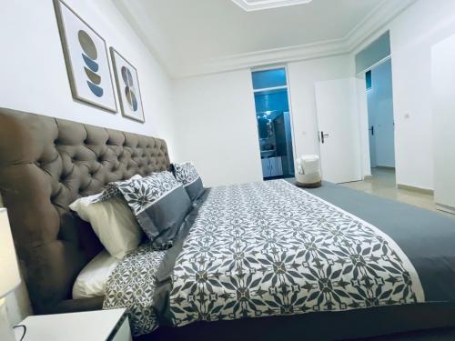 a bedroom with a large bed and a couch at ESPACE VIRAGE 2 in Dakar