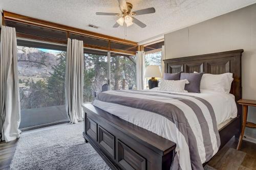 a bedroom with a large bed and a large window at 4BR Cabin Mountain Views with Fireplace in Cascade-Chipita Park