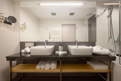 Baño con 2 lavabos y espejo en Hotel Atrium, en Split