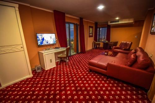 a living room with a couch and a television at HOTEL PLAZA ORAN in Oran