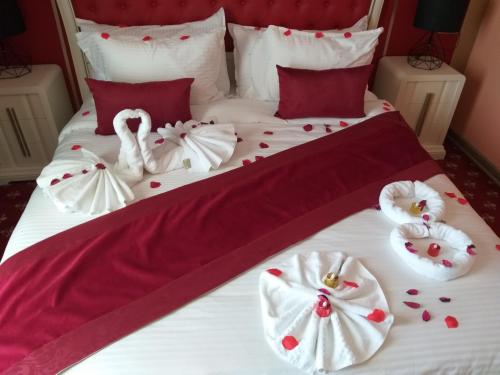 a bed with two swans and hearts on it at HOTEL PLAZA ORAN in Oran