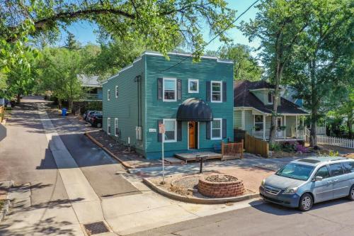 a green house with a car parked in front of it at 2 BDS Garden Of Gods - Near it all in Colorado Springs