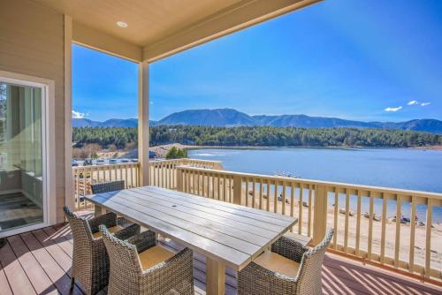 a table and chairs on a balcony with a view of the water at Luxury Lake House With Mountain Views & Hot Tub in Monument