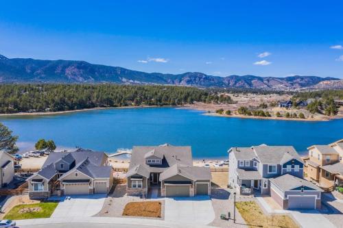 an aerial view of a house next to a lake at Luxury Lake House With Mountain Views & Hot Tub in Monument