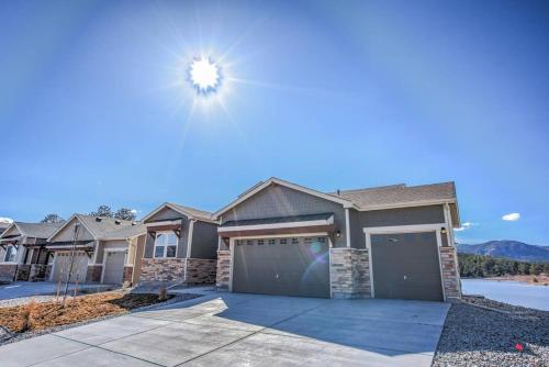 a house with a garage in front of a house at Luxury Lake House With Mountain Views & Hot Tub in Monument