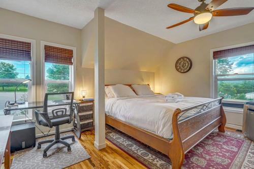 a bedroom with a bed and a desk and a chair at Charming Victorian Haven Near Garden of the Gods in Colorado Springs