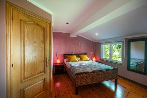a bedroom with a bed with yellow pillows on it at Villa Selina Llanes – Terraza, Vista y Playa Cerca in La Pereda de Llanes