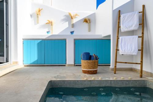 a bathroom with a swimming pool in a house at Hypnōs boutique villa with amazing heated pool with jacuzzi in Fira