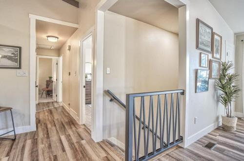 a hallway of a home with wooden floors and a staircase at 4BD With Game Lounge Hot tub Dog Friendly USAFA in Pikeview