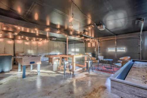 a room with a table and chairs in it at 4BD With Game Lounge Hot tub Dog Friendly USAFA in Pikeview
