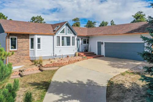 a white house with a driveway at 4BD Woodland Lodge Pool Table Grill Dogs Welcome in Monument