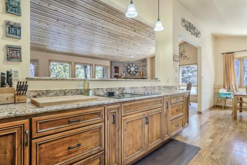 a large kitchen with wooden cabinets and a large sink at 4BD Woodland Lodge Pool Table Grill Dogs Welcome in Monument
