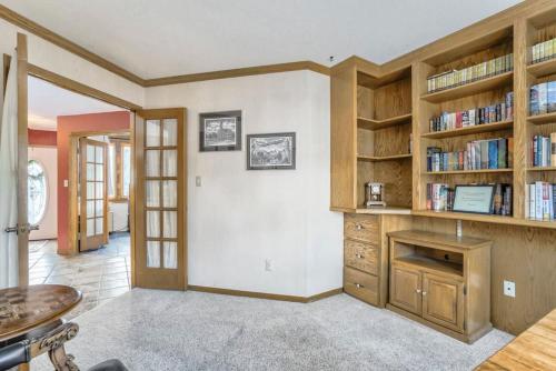 a living room with wooden book shelves and a fireplace at 4BD Woodland Lodge Pool Table Grill Dogs Welcome in Monument