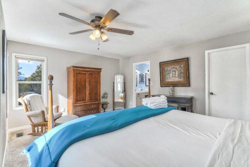 a bedroom with a bed and a ceiling fan at 4BD Woodland Lodge Pool Table Grill Dogs Welcome in Monument