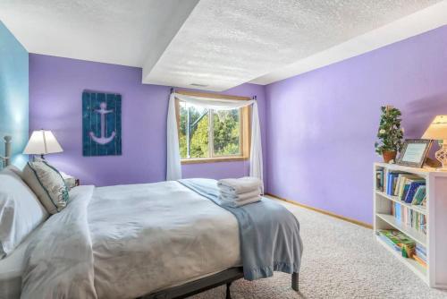 a purple bedroom with a bed and a window at 4BD Woodland Lodge Pool Table Grill Dogs Welcome in Monument