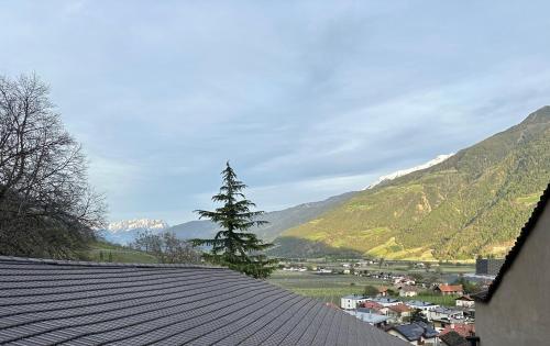 a view of a town and mountains from a roof at Weingut Köfelgut - Turris Vini in Castelbello-ciardes