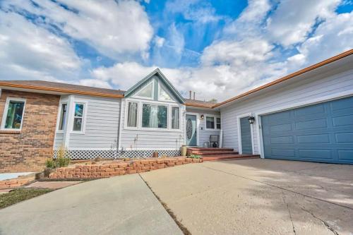 a white house with a garage at 4BD Woodland Lodge Pool Table Grill Dogs Welcome in Monument