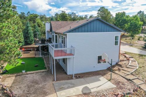 an aerial view of a tiny house with a porch at 4BD Woodland Lodge Pool Table Grill Dogs Welcome in Monument