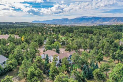 an aerial view of a home with trees and mountains at 4BD Woodland Lodge Pool Table Grill Dogs Welcome in Monument