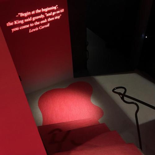 a red chair in a room with a sign at Zzz Dreamscape Hotel in Stockholm