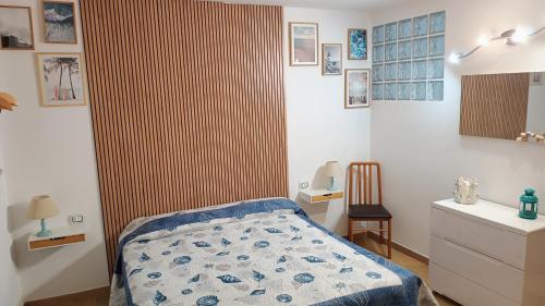 een slaapkamer met een bed en een gestreepte muur bij Casa Schiera Solanas in Solanas