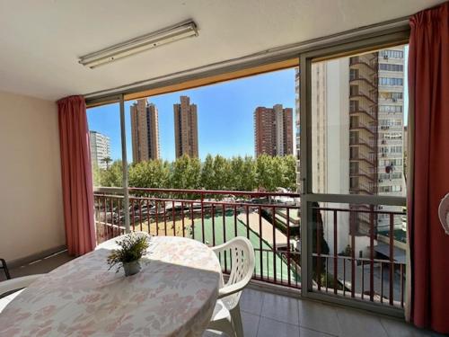 a balcony with a table and a view of a city at La Oca - Aloturin Benidorm in Benidorm