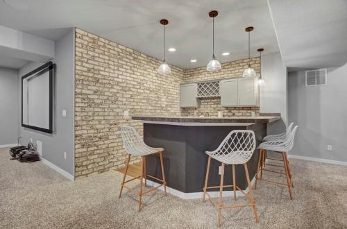 a kitchen with a counter and chairs in a room at 4BR Mountain views - Movie Theater - Pool Table in Monument