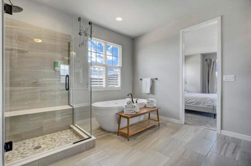 a bathroom with a shower and a tub and a sink at 4BR Mountain views - Movie Theater - Pool Table in Monument