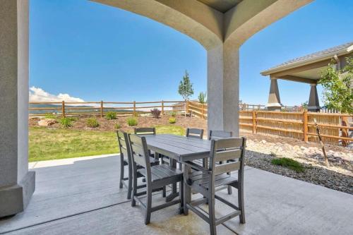 a wooden table and chairs on a patio at 4BR Mountain views - Movie Theater - Pool Table in Monument