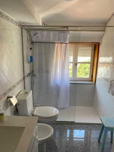 a bathroom with a toilet and a shower at Enjoy Viana - Guest House in Viana do Castelo
