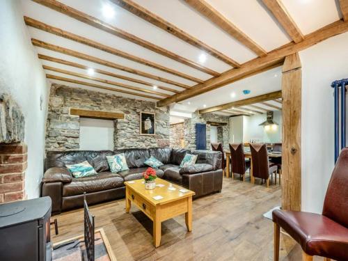 a living room with a couch and a table at Blacksmiths Cottage in Pembroke