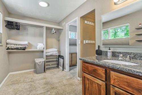 a bathroom with a sink and a mirror at Family Oasis Offices Home Gym Fenced Yard in Colorado Springs