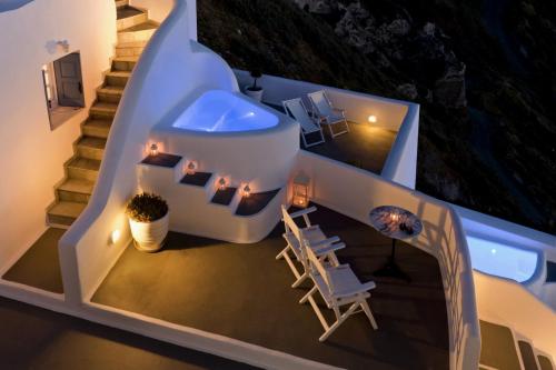 a view of a house with stairs and chairs at Kamares Apartments in Fira