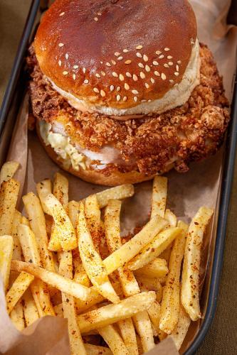 a hamburger and french fries in a tray at Assos Altın Hotel in Behramkale